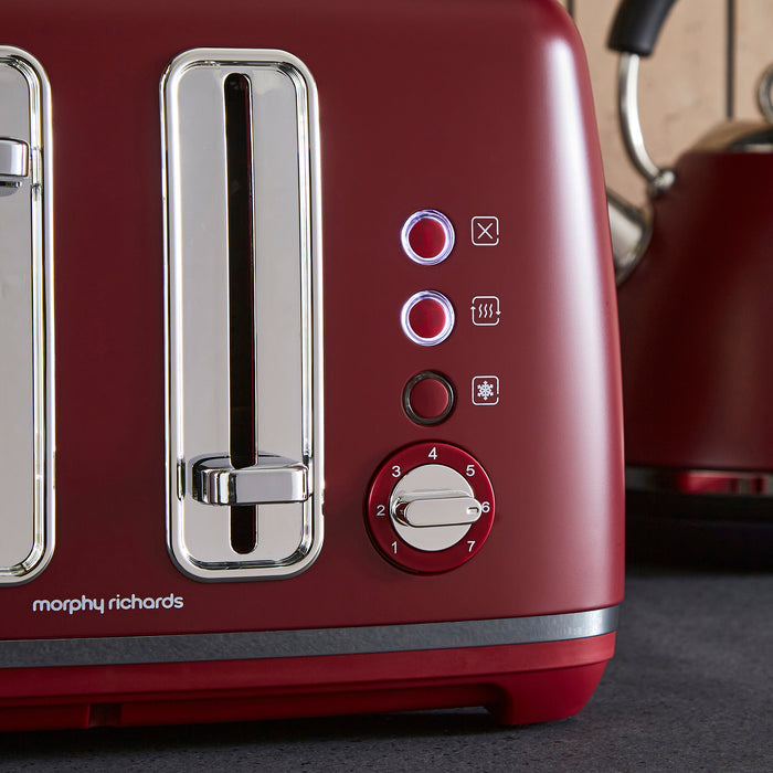 Red toaster with control panel and Morphy Richards branding on a kitchen counter.