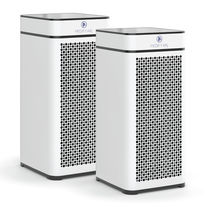 Two sleek white medifyair ma-40 air purifiers with black perforated front panels and minimalist design