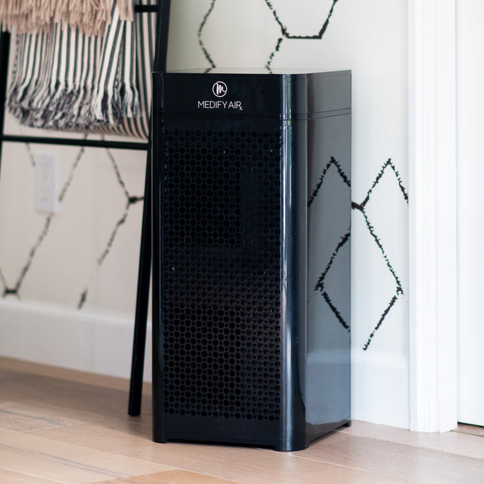 Black medify air ma-40 air purifier with sleek glossy finish and perforated front panel for efficient air cleaning