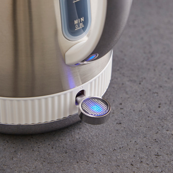 Close-up of a kitchen appliance with a blue light on a gray surface