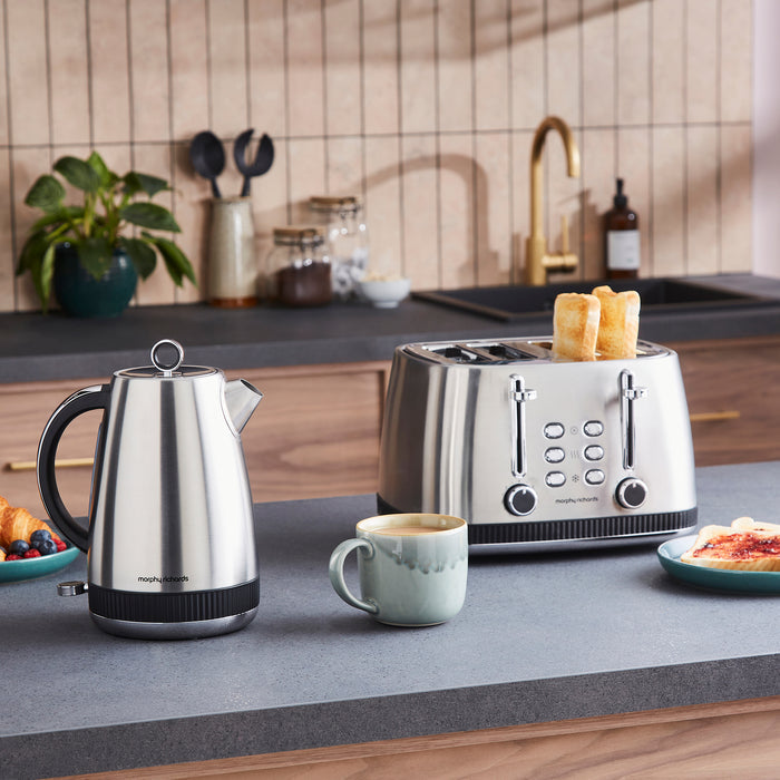 Kitchen scene with a kettle, toaster, and coffee on a countertop.