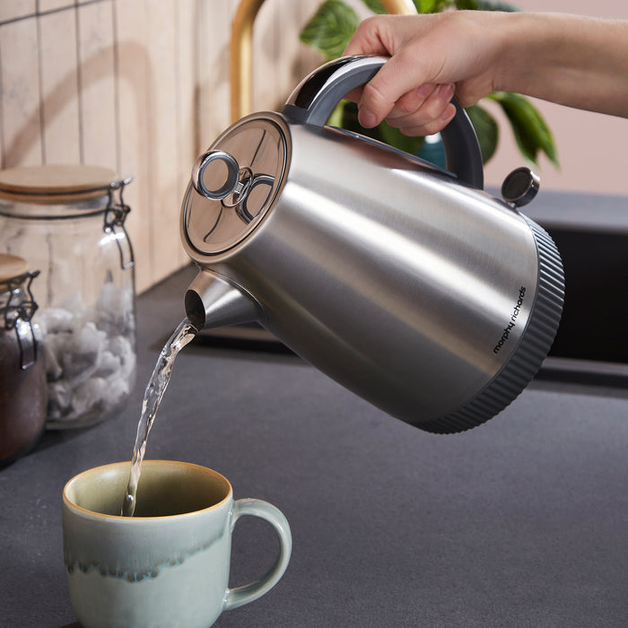 jug kettle pouring hot water into a cup