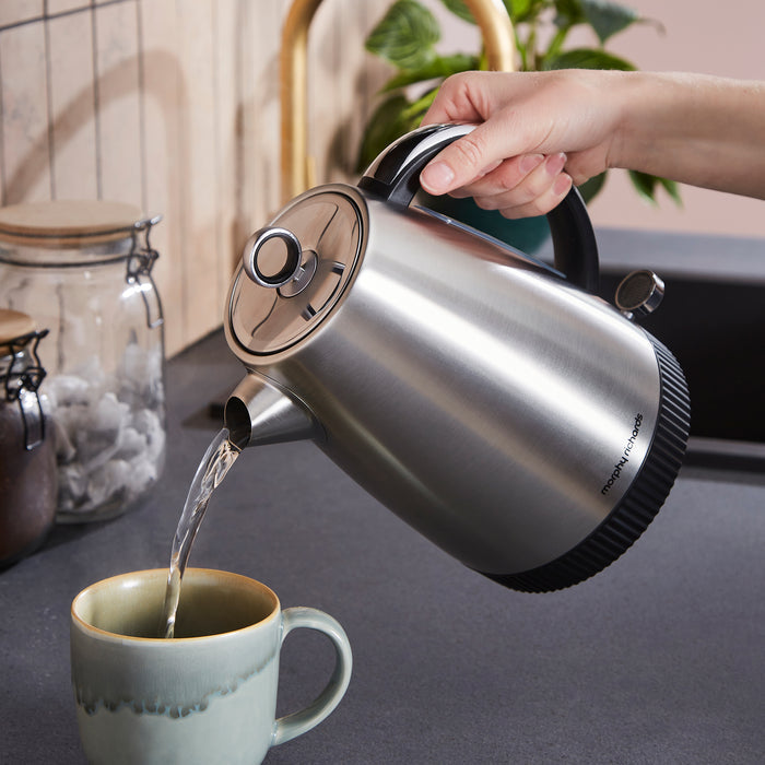 jug kettle pouring hot water into a cup