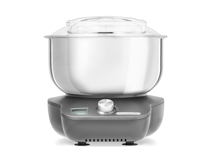 A compact silver Stand Mixer with a clear bowl, dual rotating beaters, and a splash guard.