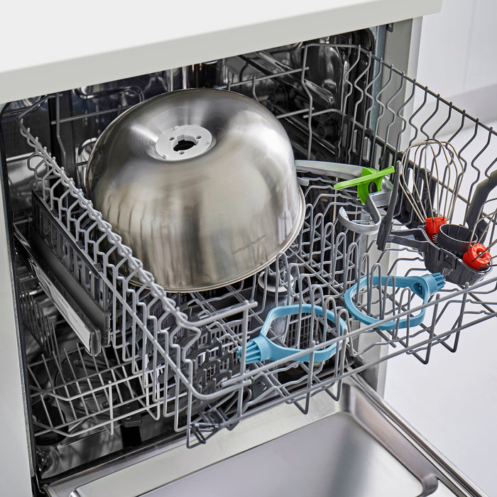 Open dishwasher with silver pot and various utensils inside