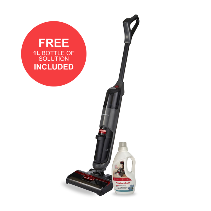 Vacuum cleaner with a bottle of cleaning solution on a white background