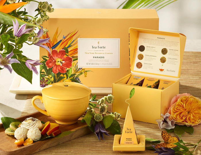 MAIN PDP | Paradis Gift Set with items shown in front of box and flowers