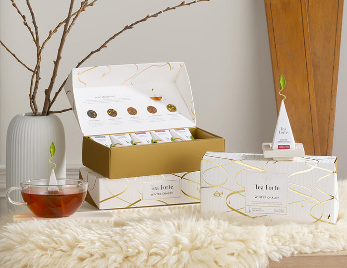 MAIN PDP | Tea packaging with a cup of tea on a soft, flurry white surface