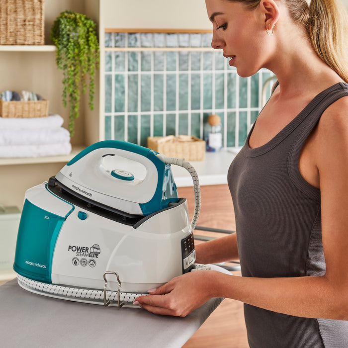 person ironing with morphy richards steam iron