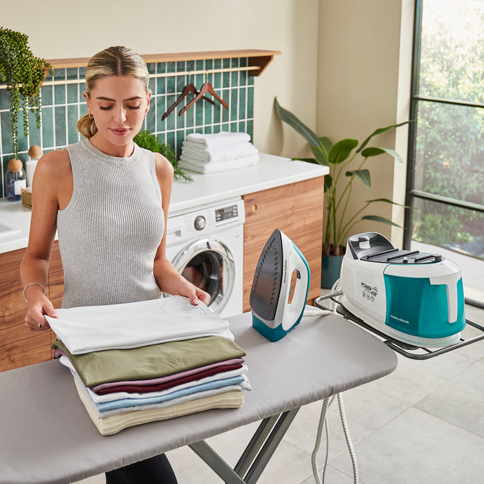 person ironing with morphy richards steam iron