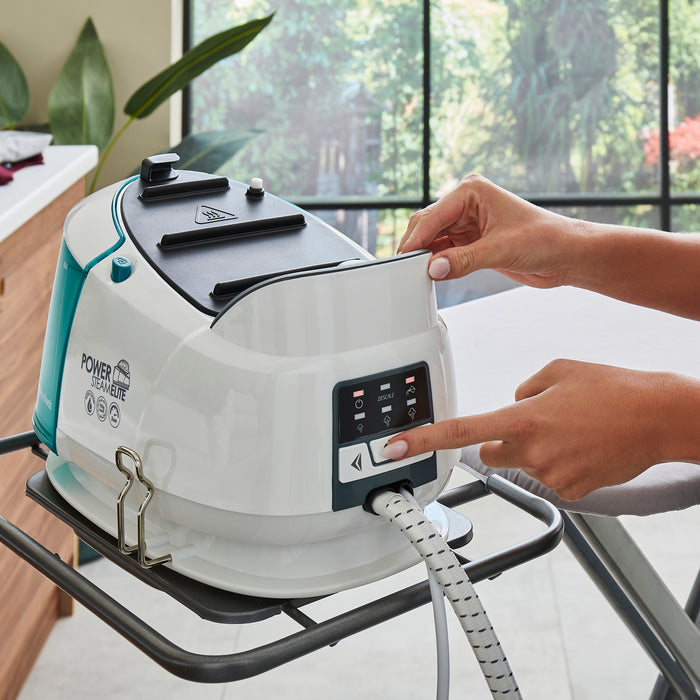 person ironing with morphy richards steam iron