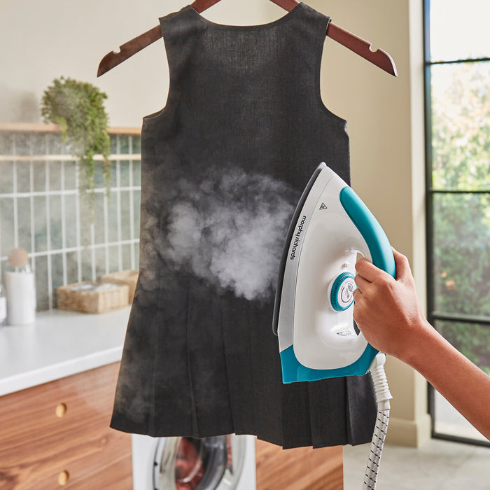 person ironing with morphy richards steam iron