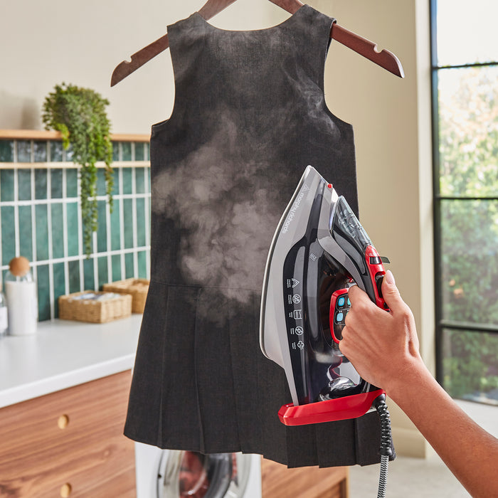 lady ironing in utility room using a morphy richards steam iron