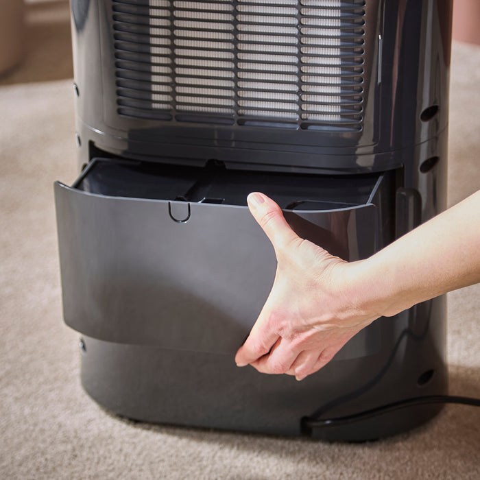 Person holding a Morphy Richards dehumidifier