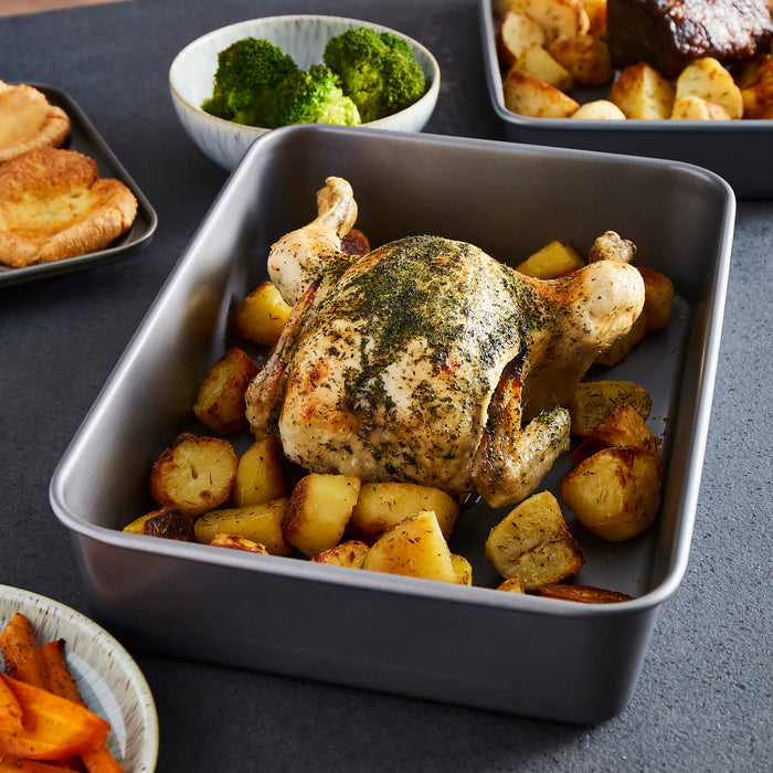 Chicken and potatoes in a roasting tin