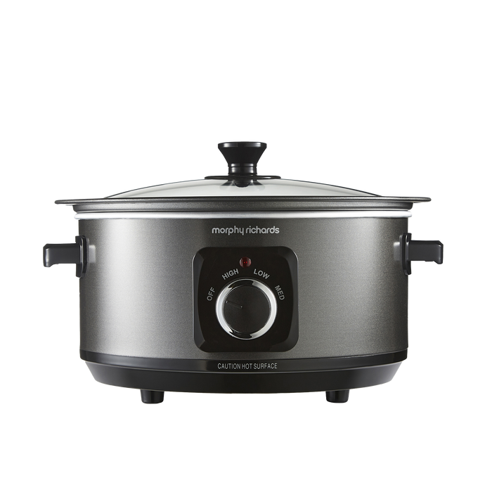 A black Morphy Richards Sear & Stew 6.5L hinged lid slow cooker with a front-facing control dial and two handles.