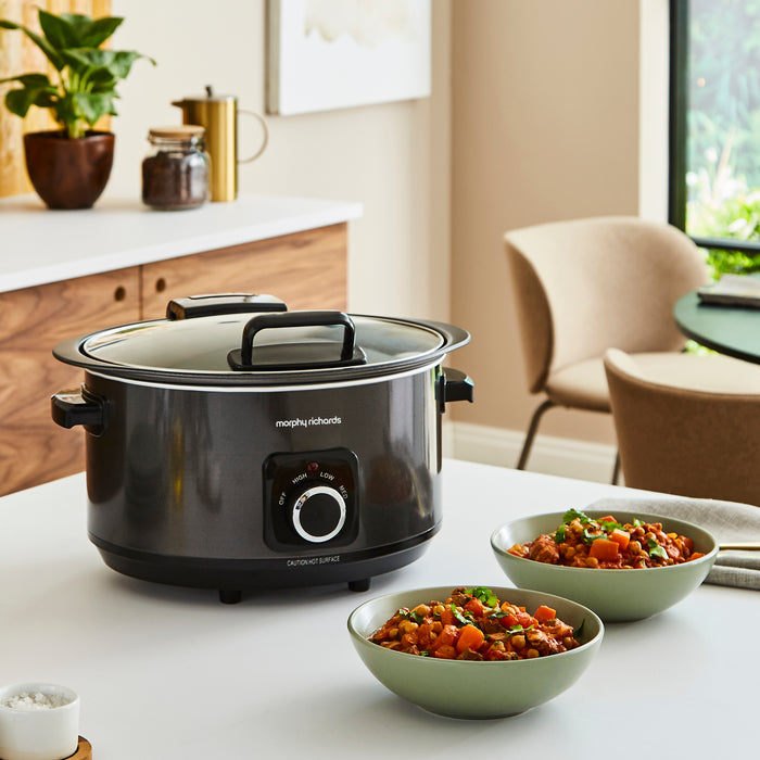 slow cooker with 2 bowls of food on a kitchen counter