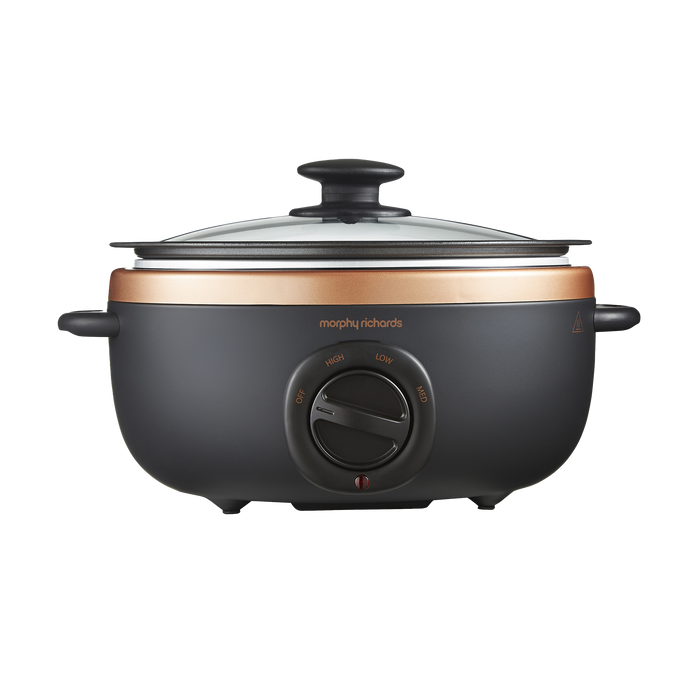 An oval-shaped black and bronze Morphy Richards Sear & Stew Slow Cooker with a glass lid.