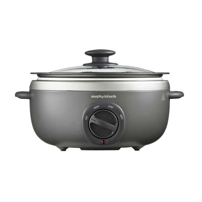 A Morphy Richards Sear & Stew Oval 3.5L Slow Cooker with a transparent glass lid and a grey aluminum cooking pot.