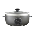 A Morphy Richards Sear & Stew Oval 3.5L Slow Cooker with a transparent glass lid and a grey aluminum cooking pot.