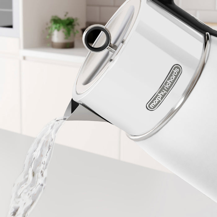 white kettle pouring water out of it in a ktichen setting