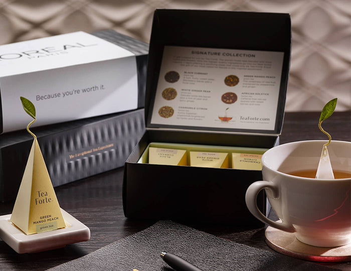 MAIN PDP | Signature Mini Petite on a desk with tea, notebook and pen