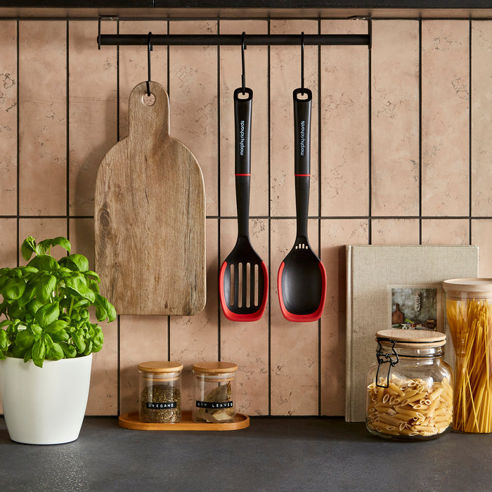 Kitchen utensils and ingredients on a tiled wall