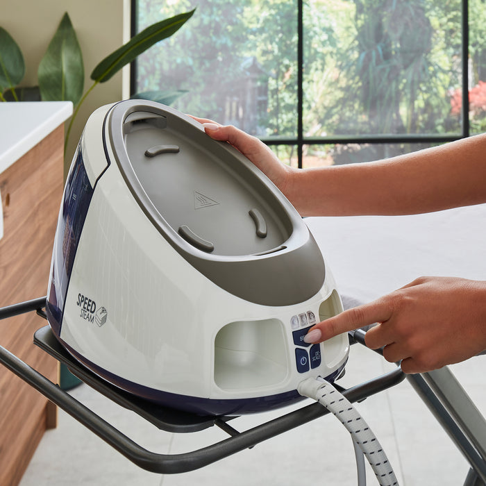 hand pressing buton on the steam generator iron control panel