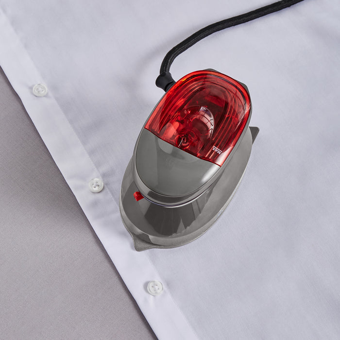 travel iron being used on white shirt