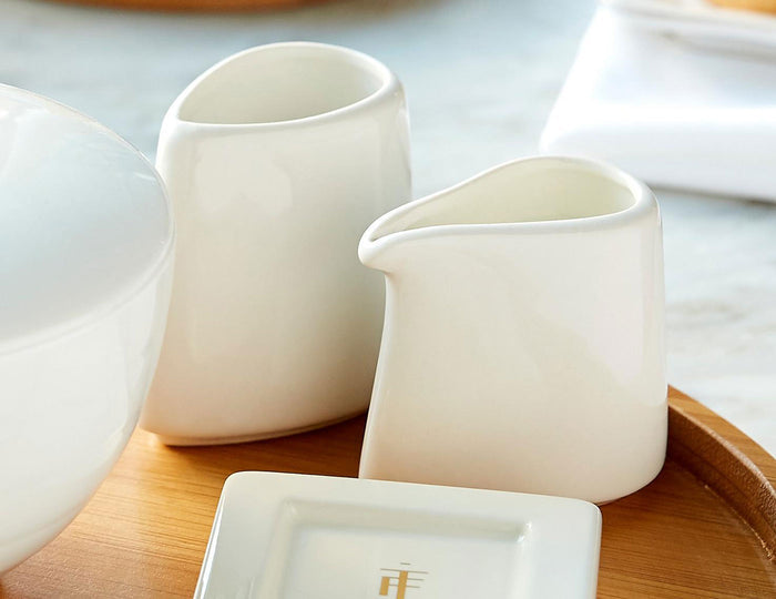 Sugar and creamer set on an oval tray with white tea tray