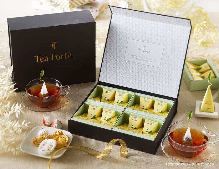 MAIN PDP | Tea Forté Select Box of 20 pyramid tea infusers, open on a table with ribbon and glass tea cups