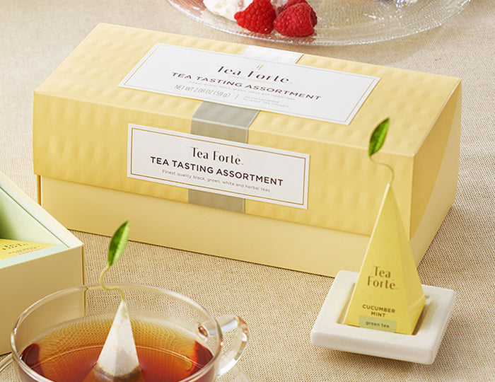 Tea Tasting Assortment in a 20 count presentation box on table with infusers, glass cups