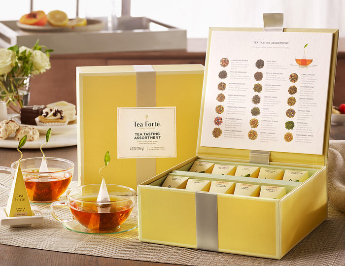 MAIN PDP | Tea Tasting tea assortment in a 40 count tea chest of pyramid infusers on table