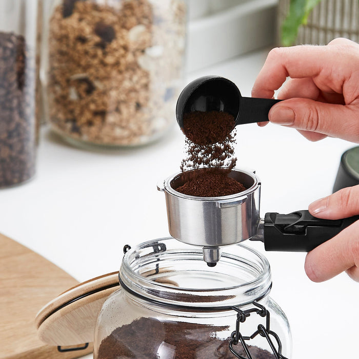 Adding ground coffee to a portafilter