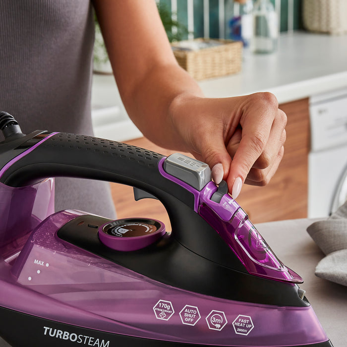 lady using morphy richards iron